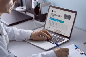 Person looking at a computer screen showing ALECs guideline and taking notes